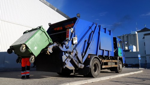 Waste clearance trucks and workers cleaning up Woodlands area