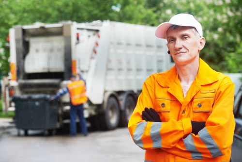 Waste clearance service truck collecting household rubbish