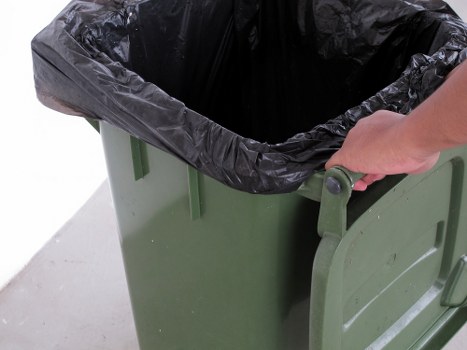 Worker handling hazardous waste safely