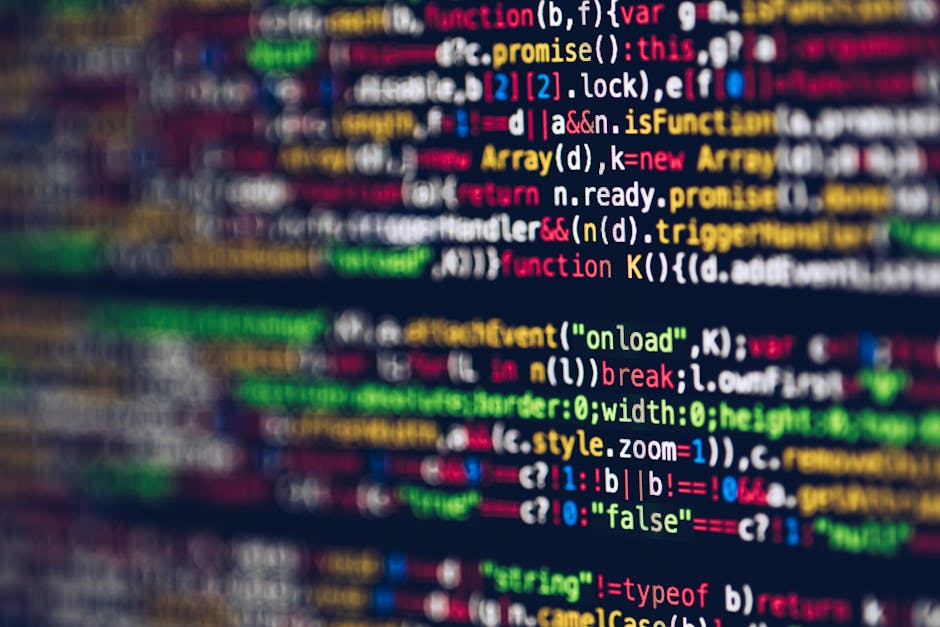A close-up image of a computer screen displaying lines of colorful programming code, including syntax in red, green, blue, yellow, and white text on a dark background. The code features various progra
